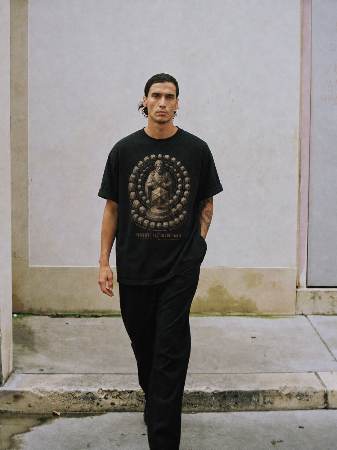 Musonius Practice Discipline black T-shirt — male Athens lifestyle shot 01