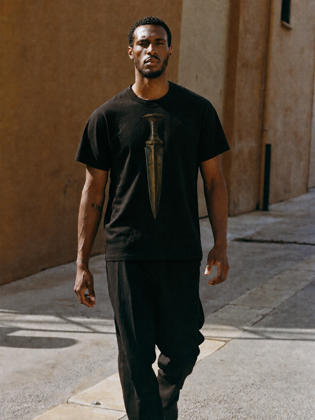 Mycenaean Gold-Weave Blade T-Shirt — male lifestyle scene 1 in Athens