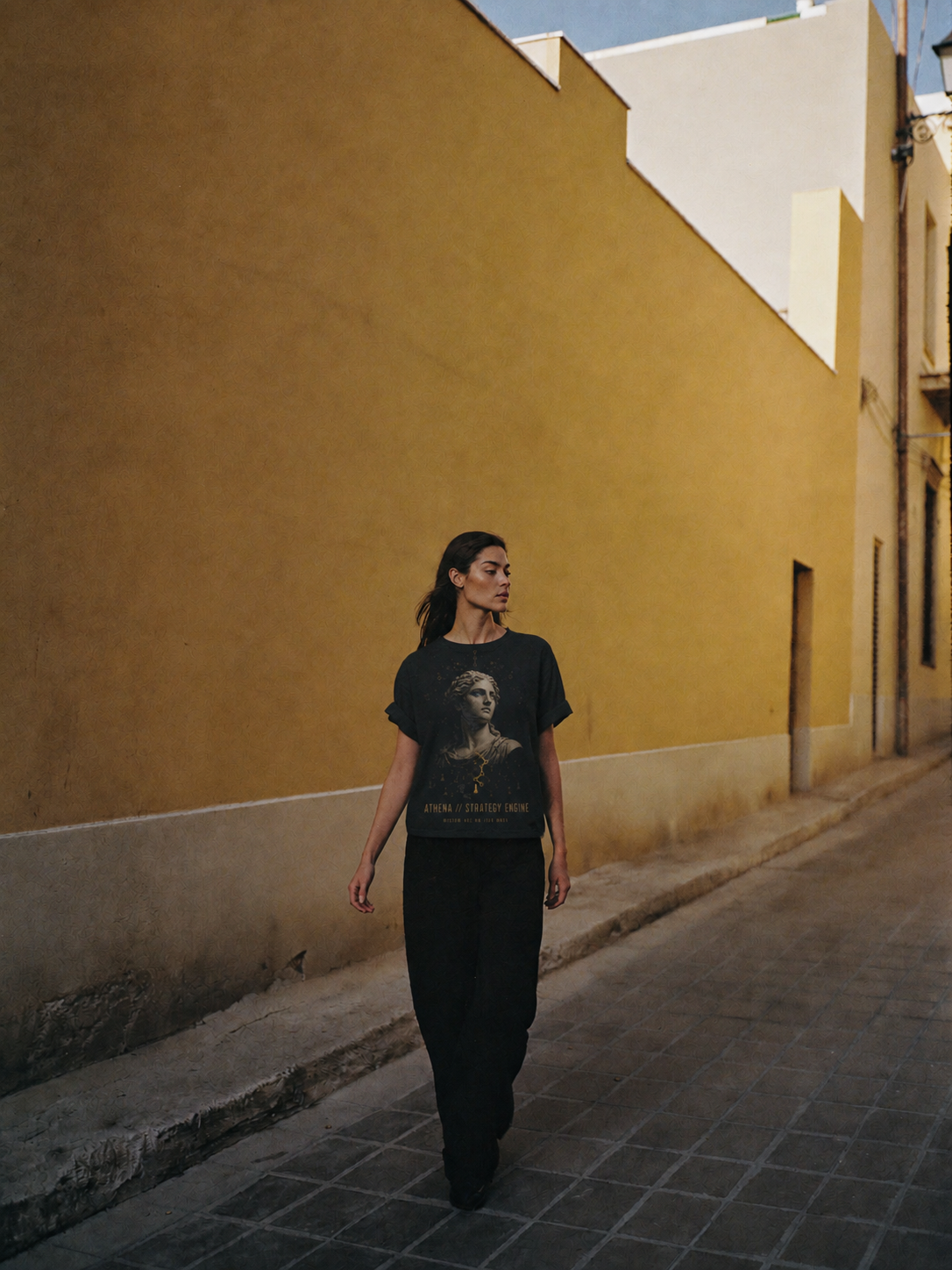 Athena Strategy Engine black T-shirt — female Athens lifestyle view 1